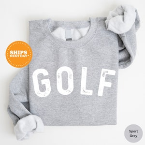 a gray shirt with the word golf printed on it