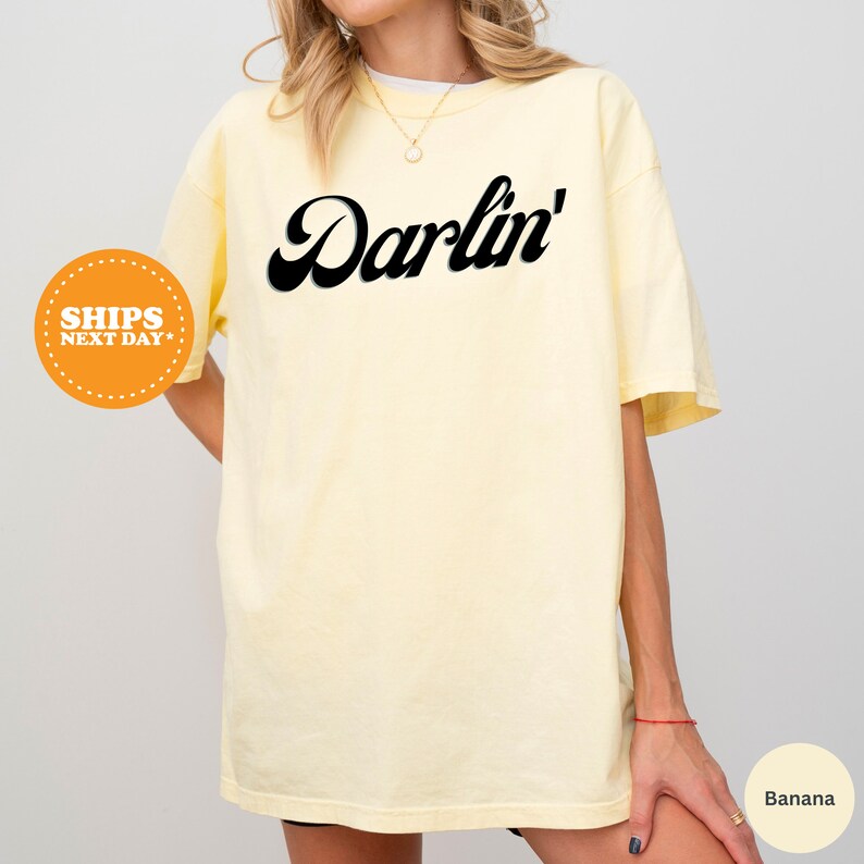 a woman wearing a yellow shirt with the word darvin on it