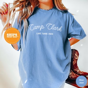 a woman wearing a blue camp clark shirt