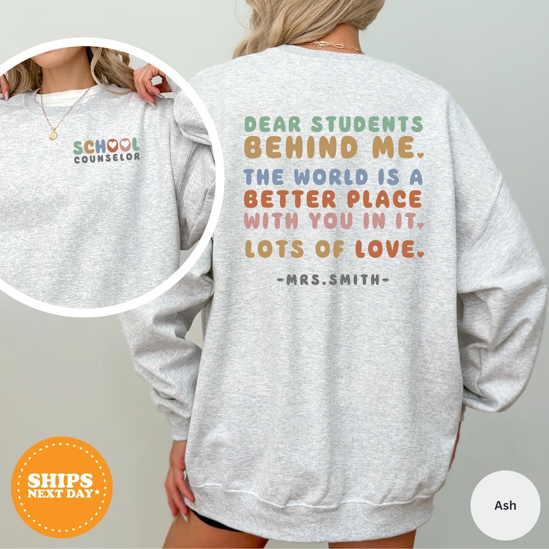 a woman wearing a sweatshirt that says dear students behind me, the world is a
