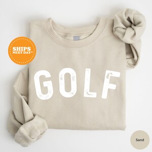 a t - shirt with the word golf printed on it