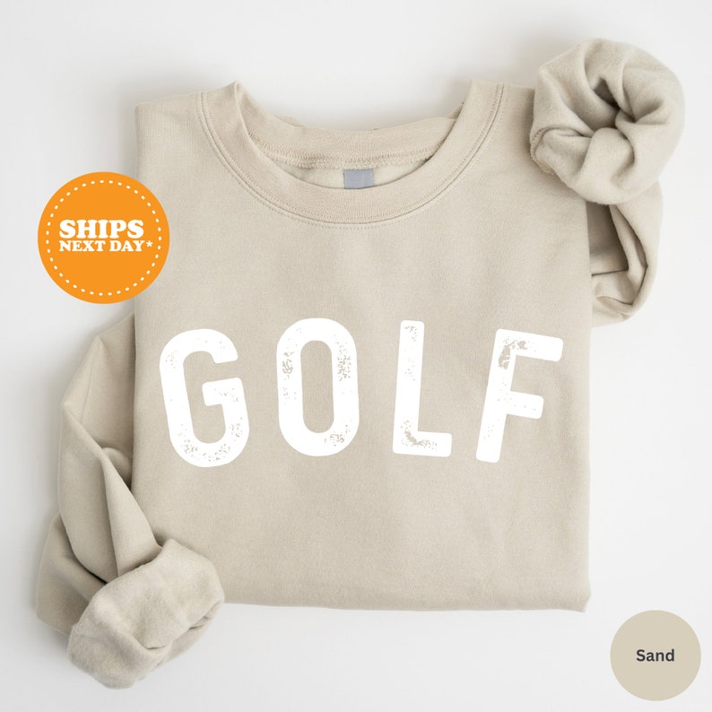 a t - shirt with the word golf printed on it