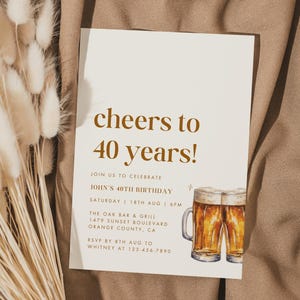 May include: A beige birthday invitation with the text "cheers to 40 years!" in brown. The invitation includes details for John's 40th birthday, a watercolor illustration of two beer mugs, and a bouquet of dried flowers.