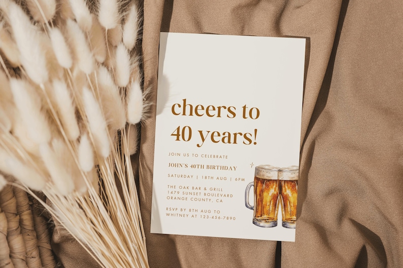 May include: A beige birthday invitation with the text "cheers to 40 years!" in brown. The invitation includes details for John's 40th birthday, a watercolor illustration of two beer mugs, and a bouquet of dried flowers.