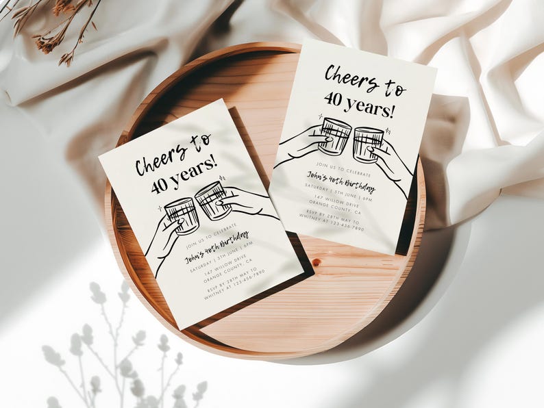 May include: Two white cards with black text and illustrations of hands holding up glasses of alcohol. The text on the cards reads "Cheers to 40 years!" and "Join us to celebrate John's 40th birthday".