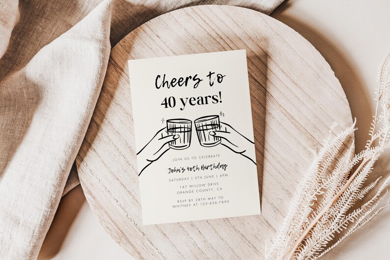 May include: A white invitation card with black text and a simple line drawing of two hands holding up glasses of alcohol. The text reads "Cheers to 40 years!" and includes details for John's 40th birthday party.