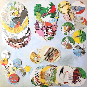 May include: A collection of circular cardboard game discs featuring various colorful illustrations, including a green dragon, a stork, a wasp, animals, and human figures, arranged in scattered stacks and individual pieces.