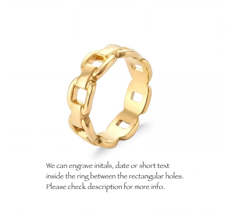 A gold-colored ring with a chain-link design, featuring a central hole surrounded by smaller holes.