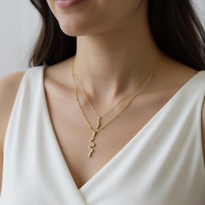 May include: A gold-colored necklace with two strands. The top strand has small beads, and the bottom strand features a snake pendant. The necklace is worn over a white top.
