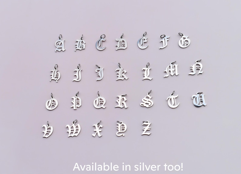 a collection of silver alphabet charms arranged in rows, each containing a single letter.