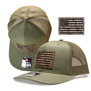 May include: Olive green trucker hat with a camouflage American flag patch. The hat features a mesh back and a curved brim. The patch is rectangular and has a brown border. The hat is adjustable and has the Richardson 112 logo.