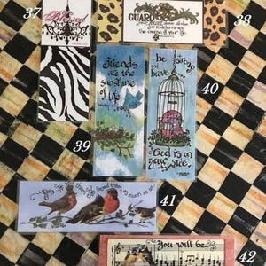 May include: A set of ten bookmarks with various designs and inspirational quotes. The bookmarks feature images of birds, cages, chandeliers, and musical notes. The quotes include "Friends are the sunshine of life", "Guard your heart above all else", "Be strong and brave", "God is on your side", and "You will be fine just you wait and see".