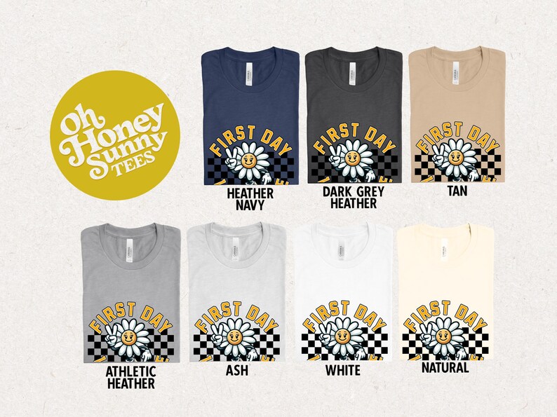 May include: A set of ten t-shirts featuring a daisy with a peace sign and the text "First Day" in a retro font. The shirts are available in a variety of colors, including heather navy, dark grey heather, tan, athletic heather, ash, white, and natural.