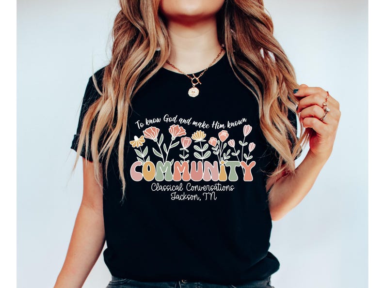 May include: Black t-shirt with a floral design and the text "To know God and make Him known COMMUNITY Classical Conversations Jackson, TN".