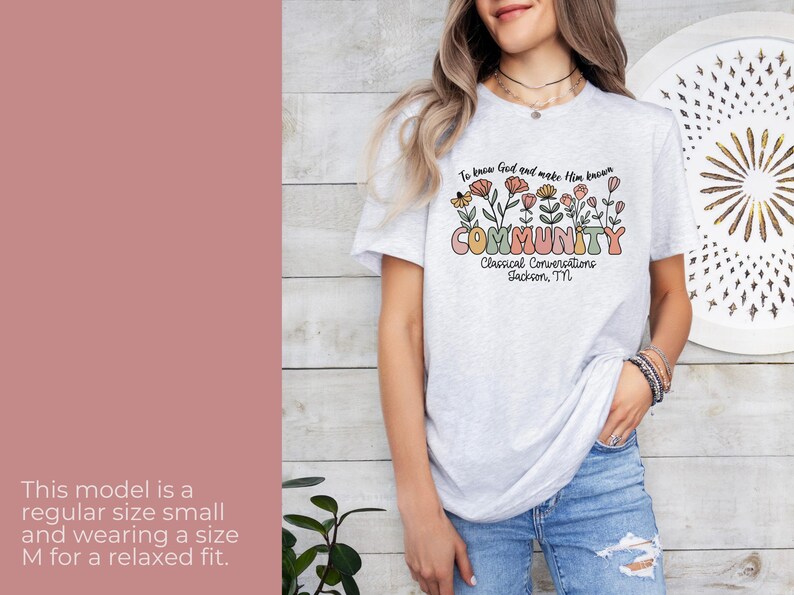 May include: A grey t-shirt with a floral design and the text "To know God and make Him known COMMUNITY Classical Conversations Jackson, TN".