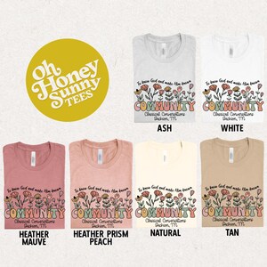 May include: A flat lay of six t-shirts in different colors, each featuring a floral design with the text "To know God and make Him known COMMUNITY Classical Conversations Jackson, TN". The t-shirts are in the colors ash, white, heather mauve, heather prism peach, natural, and tan.