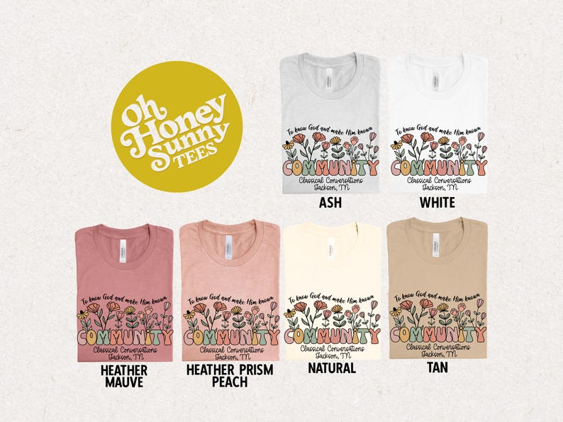 May include: A flat lay of six t-shirts in different colors, each featuring a floral design with the text "To know God and make Him known COMMUNITY Classical Conversations Jackson, TN". The t-shirts are in the colors ash, white, heather mauve, heather prism peach, natural, and tan.
