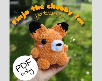 May include: A crochet pattern for a chubby fox amigurumi toy. The pattern is available as a PDF download. The image shows a crocheted fox toy in orange and black with a white nose and pink cheeks.