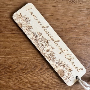May include: Wooden bookmark with a floral design and the text "I am a disciple of Christ".