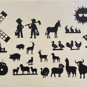 May include: Black silhouette cutouts of farm animals, a windmill, a tractor, a farmer, a sun, a milk jug, a barn, a tree, and a llama.
