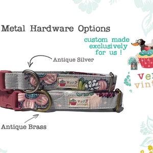 May include: Two dog collars with a floral pattern. The collars are made of gray fabric with pink and white flowers. The collars have a silver buckle and a brass buckle. The text "very vintage" is visible in the image.