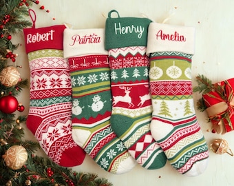 May include: Four personalized Christmas stockings with names embroidered in red thread. Each stocking features a unique pattern in red, green, and white, with snowflakes, trees, and reindeer designs. The stockings are hanging near a decorated Christmas tree.