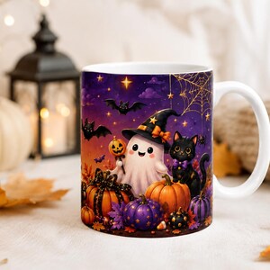 May include: A white ceramic mug featuring a colourful Halloween illustration of a smiling ghost wearing a witch hat, a black cat, and various orange and purple pumpkins. The background depicts a starry night sky with bats and a spider web.