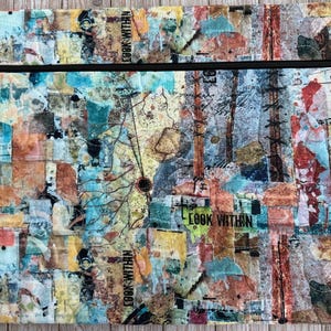 May include: A rectangular, quilted fabric case with a black zipper. The case features a collage of colorful, abstract shapes in shades of blue, orange, and brown. The words "LOOK WITHIN" are printed on the case.