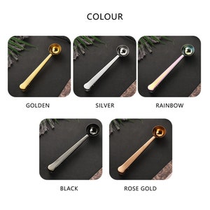 May include: Five different colored coffee scoop clips. The scoops are gold, silver, rainbow, black, and rose gold. The scoops are all the same size and shape. They are made of metal and have a clip on the end to hold them to the side of a coffee bag.