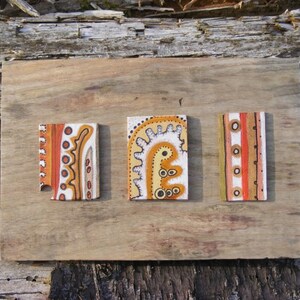 Aboriginal style abstract painted leather tiles on wood
