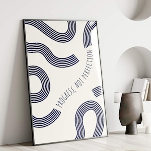 May include: A white poster with a navy blue abstract design and the text "Progress, not perfection".