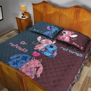 May include: A quilted bedspread with a cartoon character design. The bedspread features a blue and maroon color scheme with the words "Or refunds" and "Returns". The design includes cartoon characters and a heart.