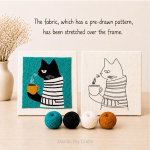 May include: Two square frames with fabric featuring a cat in a striped sweater holding a mug. One frame shows a finished teal, black, white, and yellow punch needle design, while the other shows a black outline. Four yarn balls sit in front.