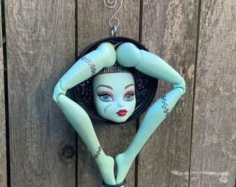 Freaky upcycled Monster High Frankie Stein doll wall plaque - plastic bottle cap resin art