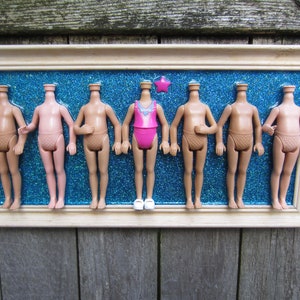 Weird framed doll art, Upcycled assemblage