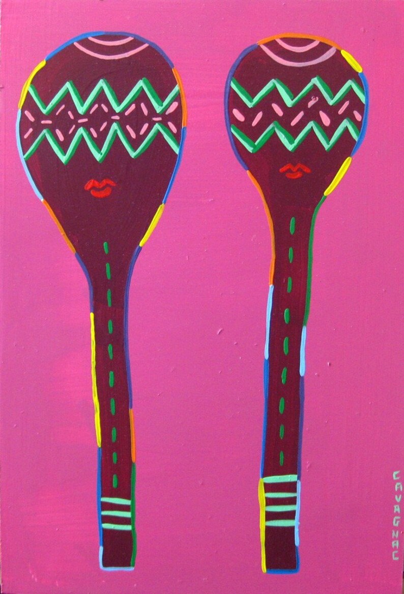 May include: Two wooden spoons painted in a vibrant pink, green, red, yellow, and blue color scheme. The spoons have a zig-zag pattern and a red mouth painted on the top of each spoon.