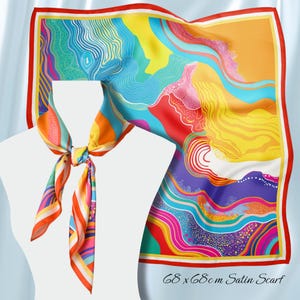 May include: A colorful satin scarf, 68 x 68cm, with a vibrant abstract design. The scarf features a red border and a dynamic pattern of blues, yellows, oranges, and purples. The scarf is tied in a knot, showcasing its versatility.