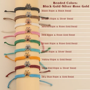 May include: Ten bracelets with different colored ropes and beads. The beads are paw prints with a clear center. The rope colors are black, brown, white, pink, green, cyan, yellow, wine red, and sky blue. The beads are black, silver, rose gold, and gold.