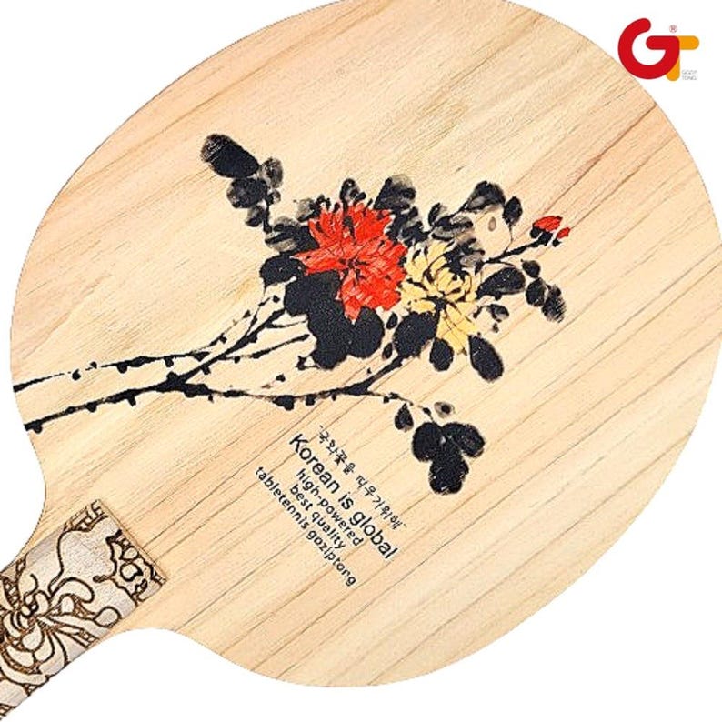 May include: A wooden table tennis paddle with a black and white floral design and the text "Korean is global, high-powered, best quality, tabletennis gaziptong" in Korean and English.
