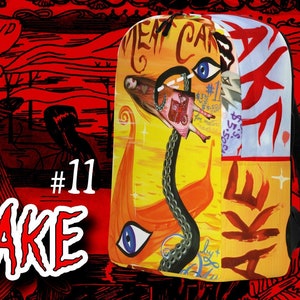 Op de afbeelding: Een gele en oranje rugzak met een zwarte band en een kleurrijk ontwerp met een vrouw, een ketting en een oog. De rugzak heeft de tekst "MEAT CAKE" erop gedrukt. De tekst "#11" is ook zichtbaar.
