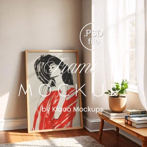 May include: A framed art print featuring a woman in a hat and red dress. The artwork is in a wooden frame and leans against a wall. The words "Frame MOCKUP by Klaoo Mockups" are displayed on the artwork.