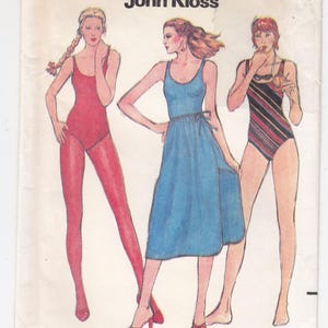 May include: A Butterick 6539 sewing pattern envelope by John Kloss, size 14. The front features illustrations of three outfits: a solid red one-piece swimsuit, a blue sleeveless dress with a tie waist, and a striped one-piece swimsuit.