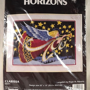 May include: Cross stitch pattern featuring a red and blue angel with a golden horn blowing against a dark blue background with gold stars. The pattern is titled "Clarissa" and is a Monarch Horizons design by Roger W. Reinardy. The design size is 20 inches by 14 inches.