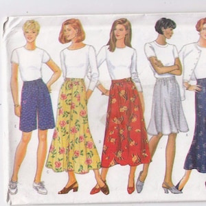 May include: A sewing pattern illustration featuring five figures in various outfits. The outfits include shorts, skirts, and tops. The skirts are in floral patterns, and the tops are white. The pattern is for sizes XS-S-M.