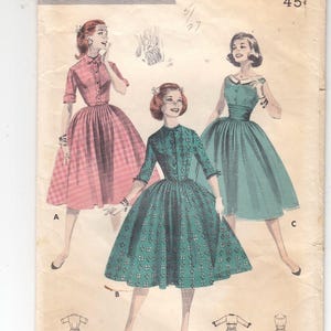 May include: Vintage Butterick printed pattern featuring illustrations of three dresses. The dresses are in pink and teal, with fitted bodices and full skirts. The pattern includes bust size 30 and size 10.