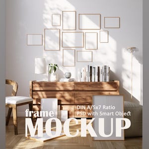May include: A mockup of a wooden dresser with a variety of framed pictures on the wall above it. The frames are all different sizes and shapes, and they are arranged in a random pattern. The dresser is made of wood and has a light brown finish. There are two large white frames on the dresser, one with the text "frame mockup" and the other with the text "DIN A/5x7 Ratio PSD with Smart Object".