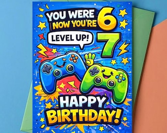 May include: A birthday card with a blue background. It features two game controllers, one blue and one green, and the text "You Were Now You're Level Up!" and "Happy Birthday!" with the numbers 6 and 7.