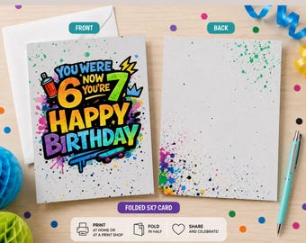 May include: A folded 5x7 inch birthday card featuring a graffiti-style design with the text You Were 6 Now You're 7 Happy Birthday. The card displays a colourful paint splatter background, a spray paint can, and a skateboard graphic in vibrant hues.