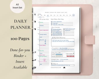 May include: A5 insert set for a daily planner with 100 pages. The open planner shows a detailed layout with sections for appointments, tasks, and notes. The cover is a light pink color, and the text "DAILY PLANNER" is visible.