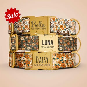 May include: Three personalized dog collars with floral patterns in shades of orange, brown, and white. Each collar features a gold-colored buckle with a name and phone number. A red starburst graphic with the word "Sale" is in the upper left corner.